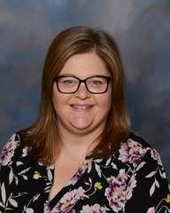 woman with black flowery shirt and glasses 